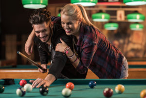 Man and woman playing pool
